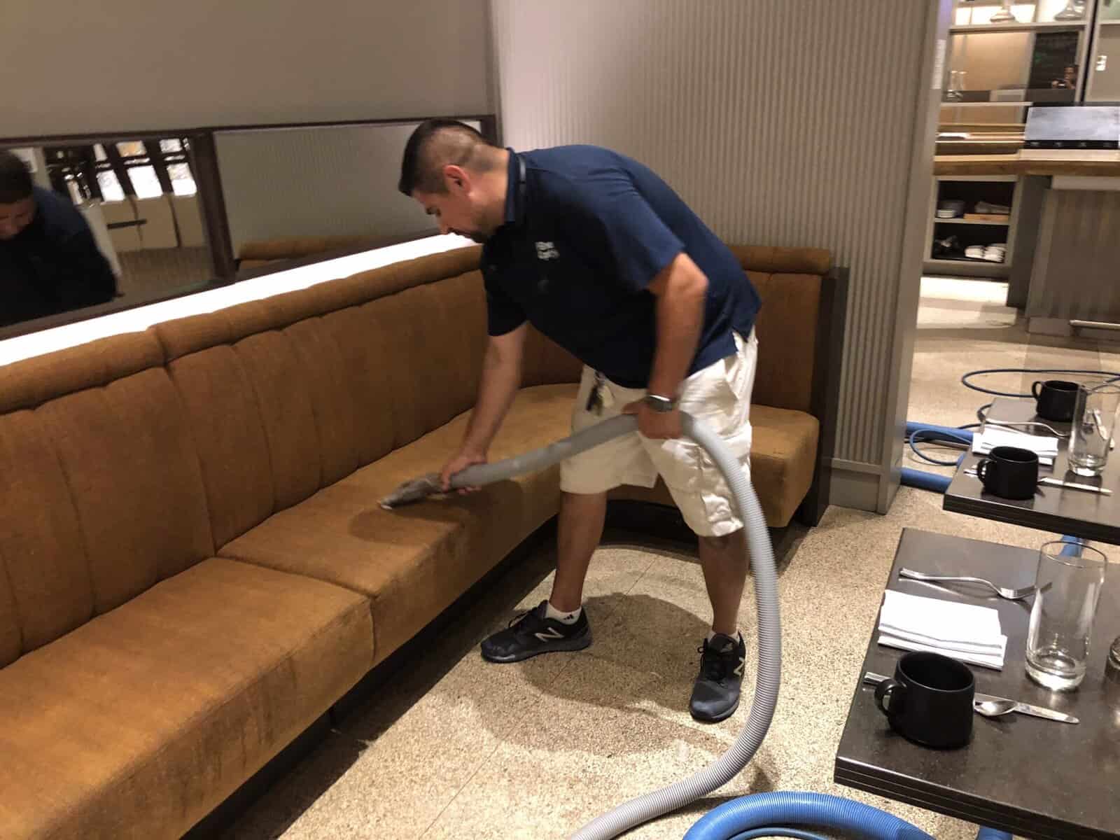 Commercial upholstery cleaning in Raleigh & Durham NC – ProGreen technician cleaning office chairs and sofas