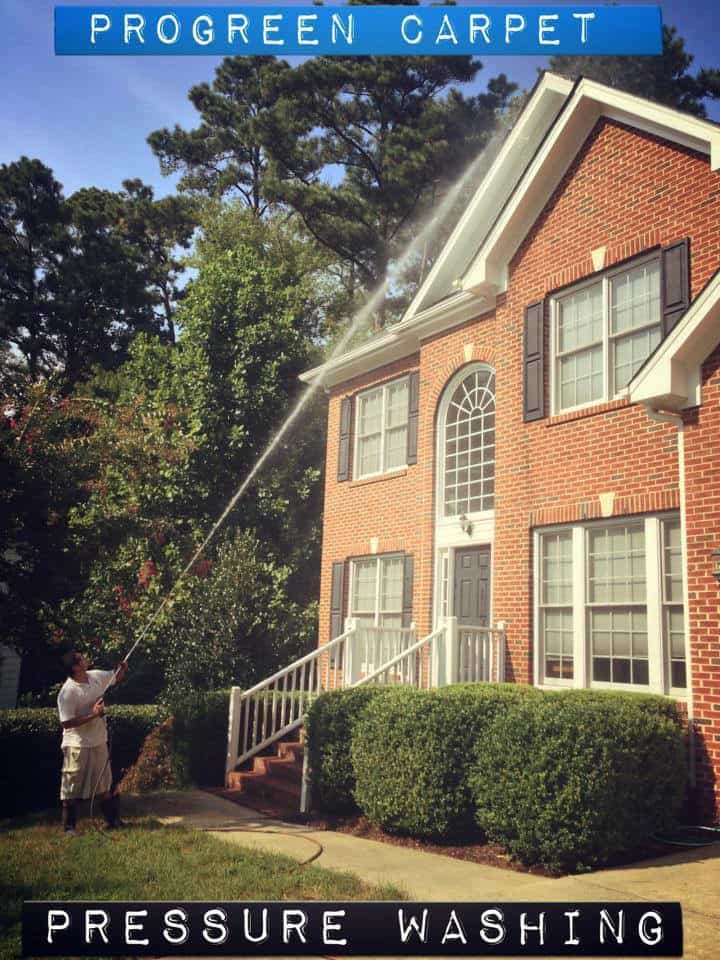 Pressure washing in Raleigh & Durham NC – ProGreen technician cleaning home driveway and siding