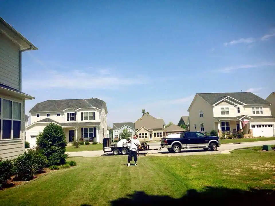ProGreen Carpet technician pressure washing house exterior siding in Durham Raleigh NC home